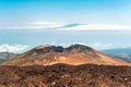 Crater of Pico Viejo volcano on a blue cloudscape background