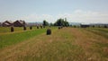 Over Picturesque haycocks on yellow field. Aerial fast fly