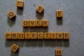 Over Protective on wooden cubes. On table background