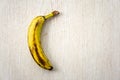 Over ripe banana isolated on wooden background.