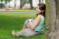 Over should look of young attractive fresh woman at the park writes in notebook journal Royalty Free Stock Photo