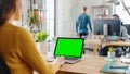 Over the Shoulder: Creative Young Woman Sitting at Her Desk Using Laptop with Mock-up Green Screen Royalty Free Stock Photo