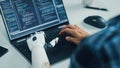 Over Shoulder Hands Close-up: Programmer With Disability Using Prosthetic Arm to Work on Laptop Royalty Free Stock Photo