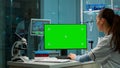 Over the shoulder shot of chemist working with green screen Royalty Free Stock Photo