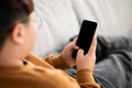 Over shoulder shot of chubby boy using cellphone, mockup Royalty Free Stock Photo