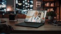 Over the Shoulder Shot of a Female Using Laptop for a Video Call to a Senior Male Doctor at Home Royalty Free Stock Photo