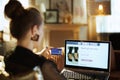 Trendy woman with credit card buying shoe while shop online