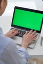 Over The Shoulder View Of Businesswoman Using Green Screen Laptop In Office Royalty Free Stock Photo