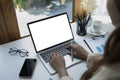 Over shoulder view businesswoman working with laptop computer. Royalty Free Stock Photo