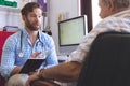 Male doctor prescribing medicament  to senior man in clinic Royalty Free Stock Photo