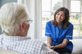 Over shoulder view of nurse on home visit with senior man Royalty Free Stock Photo