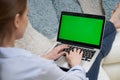 Over The Shoulder View Of Woman Lying On Sofa Using Green Screen Laptop Royalty Free Stock Photo