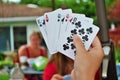 Over the shoulder view of a young woman playing cards Royalty Free Stock Photo