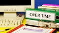 Over time-a text label on the office Registrar folder. Royalty Free Stock Photo