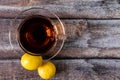 Over the top shot of black tea, lemon on wooden texture with copy space Royalty Free Stock Photo