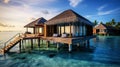 : Over water villas line in Maldivas with wooden foot bridge at sunset, holiday ad travel concept