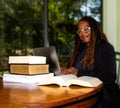 Smiling Older African-American Woman Studying/Working with Books/Laptop Royalty Free Stock Photo