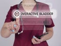 OVERACTIVE BLADDER OAB text in list. Geneticist looking for something at smartphone Royalty Free Stock Photo