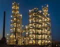 Overall view of an oil refinery illuminated at night, pipelines Royalty Free Stock Photo