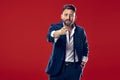 The overbearing businessman point you and want you, half length closeup portrait on red background. Royalty Free Stock Photo