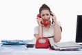 Overbooked businesswoman answering the phones Royalty Free Stock Photo