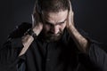 Overburdened frustrated man covering ears and looking despaired. Royalty Free Stock Photo