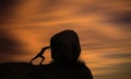 Overcame Obstacles, Sisyphus and Hard Work Concept. Young man Pushing Big Rock Forward At sunset.