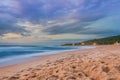 Overcast cloudy sunrise over a rough Indian Ocean from a view point on a beach in Port Shepstone