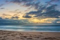 Overcast cloudy sunrise over a rough Indian Ocean from a view point on a beach in Port Shepstone