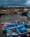 Brightly painted small boats in Whitby Harbor