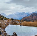 Overcast morning autumn alpine Dolomites mountain scene. Peaceful Valparola Path and Lake view, Belluno, Italy Royalty Free Stock Photo