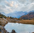 Overcast morning autumn alpine Dolomites mountain scene. Peaceful Valparola Path and Lake view, Belluno, Italy Royalty Free Stock Photo