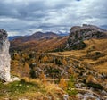 Overcast morning autumn alpine Dolomites mountain scene. Peaceful Valparola Path view, Belluno, Italy. Snowy Marmolada massif and Royalty Free Stock Photo