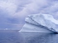 Overcast sky above large iceberg stranded in Twillingate Harbour