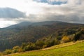 Overcast sky over meadow and forest in autumn colors, mountain Goc Royalty Free Stock Photo