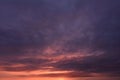 Overcast sky in thunderclouds in the fiery lava of sunlight at sunset