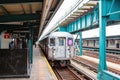 Overcast view of a subway station with a train coming in Royalty Free Stock Photo