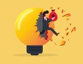 Overcoming obstacles. businessman holding a bag of money and jumping out of a broken light bulb