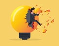 Overcoming obstacles. businessman holding a light bulb and jumping out of a broken light bulb