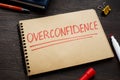 Overconfidence concept word written on the page.
