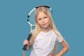 Overconfident elementary school girl with tennis racket