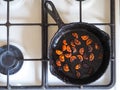 Overcooked onion in a pan. A bad kitchen. The concept of harmful food and carcinogens.