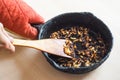 Overcooked onion in a pan. A bad kitchen. The concept of harmful food and carcinogens.