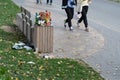 Overcrowded trash basket in street. Garbage concept. Pile of plastic waste trash on floor and grass Royalty Free Stock Photo