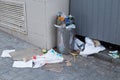 Overcrowded trash can on city street. Royalty Free Stock Photo