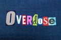 OVERDOSE text word collage, colorful fabric on blue denim, addiction and abuse concept