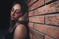 Overdosed drug addicted woman near brick wall. Space for text Royalty Free Stock Photo