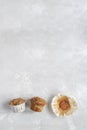 Overeating concept - half-eaten muffins, grey background, copy space, top view