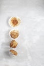 Overeating concept - half-eaten muffins, grey background, copy space, top view