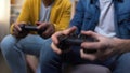 Overemotional multiethnic teenage boys winning computer game, hands close-up